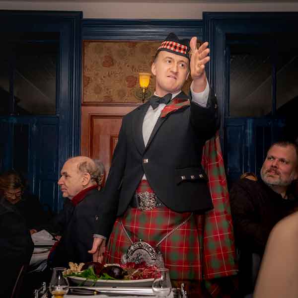 Gage & Tollner host Tyler Caffall addresses the haggis.