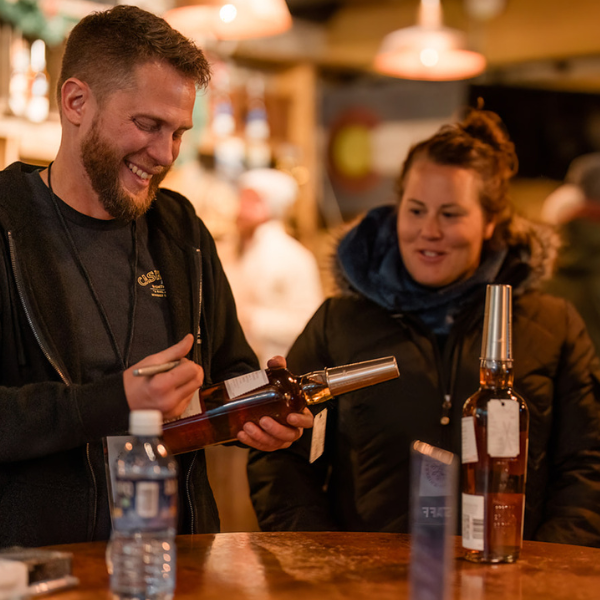 Stranahan's master blender Justin Aden signs a bottle of Snowflake.