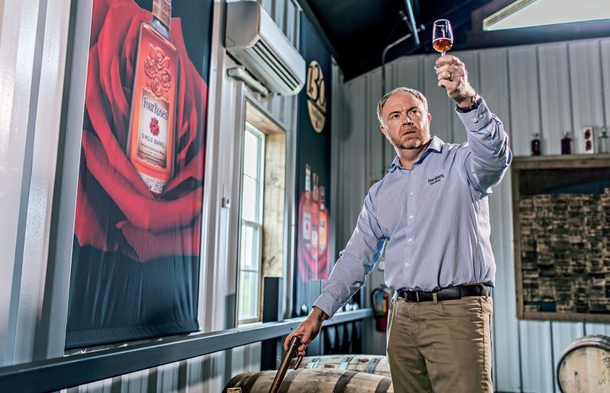 Four Roses master distiller Brent Elliott pulls a sample from a barrel. PHOTOGRAPH BY JEFF HARRIS