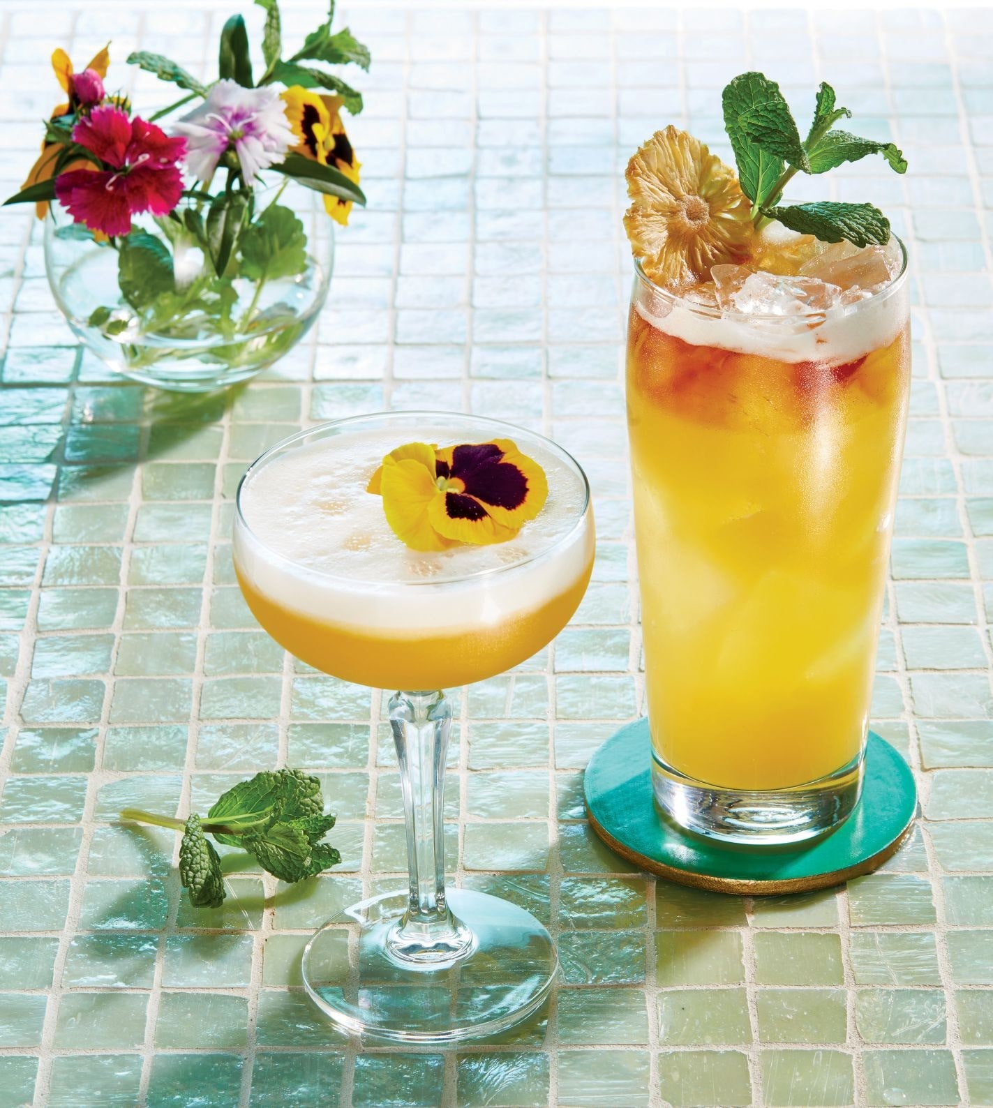 Summer in Taiwan (left) is built with Kavalan whisky as its base. Rhiskey Pineapple incorporates Irish whiskey, coconut rum liqueur, and pineapple juice. PHOTOGRAPH BY JEFF HARRIS • DRINK STYLING BY TYNA HOANG